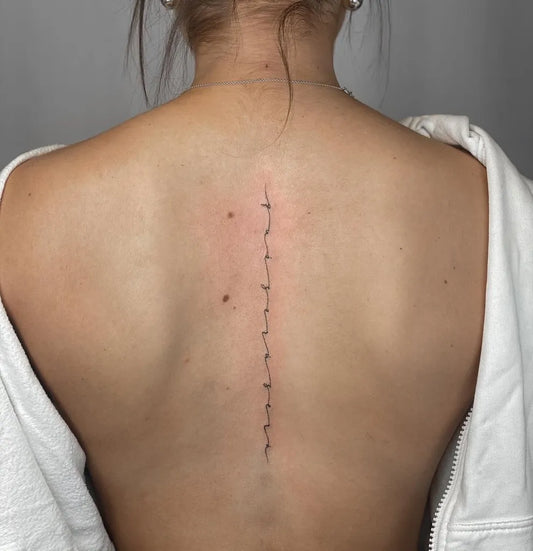 Small Minimalist Line Work on Women Spine Tattoo by @bakken_tattoo