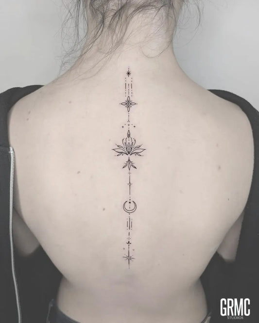 Small Minimalist Lotus Mandala on Women Spine Tattoo by @grmcstudios