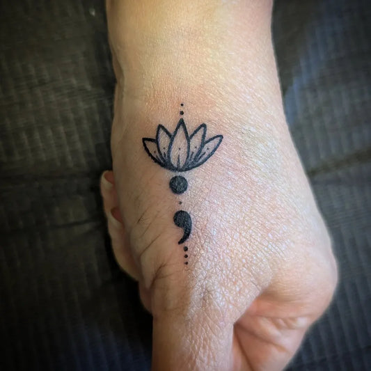 Small Minimalist Lotus Semicolon on Women Wrist Tattoo by @whimmmsy