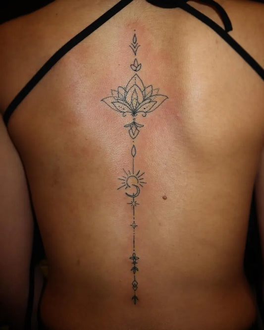 Small Minimalist Lotus Sun on Women Spine Tattoo by @huseyin_tattoos