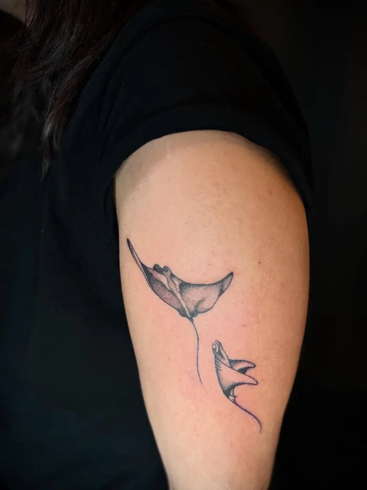 Small Minimalist Manta Ray Family on Women Arm Tattoo by @pleure.madeleine