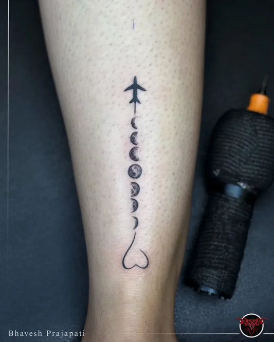 Small Minimalist Moon Phases Airplane Heart Tattoo on Women Leg by @red_devil_tattooz__