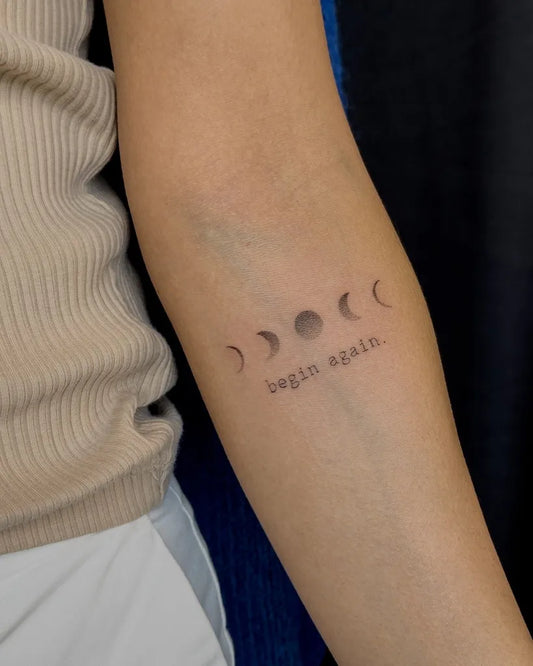 Small Minimalist Moon Phases Quote Tattoo on Women Arm by @lukas.ejsmont
