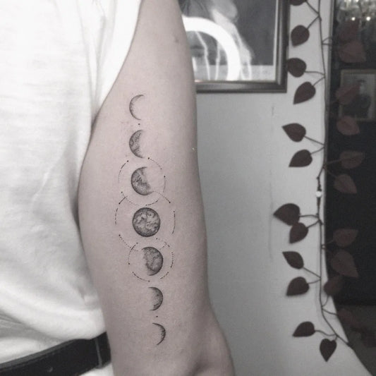 Small Minimalist Moon Phases Tattoo on Men Arm by @plathtattoo