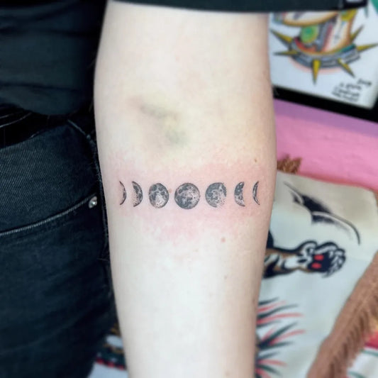 Small Minimalist Moon Phases Tattoo on Women Arm by @hannahsenoj