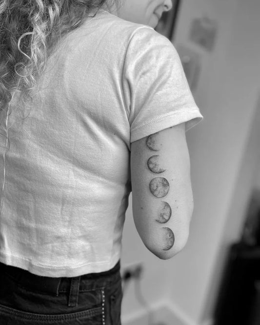 Small Minimalist Moon Phases Tattoo on Women Arm by @lanietattoos