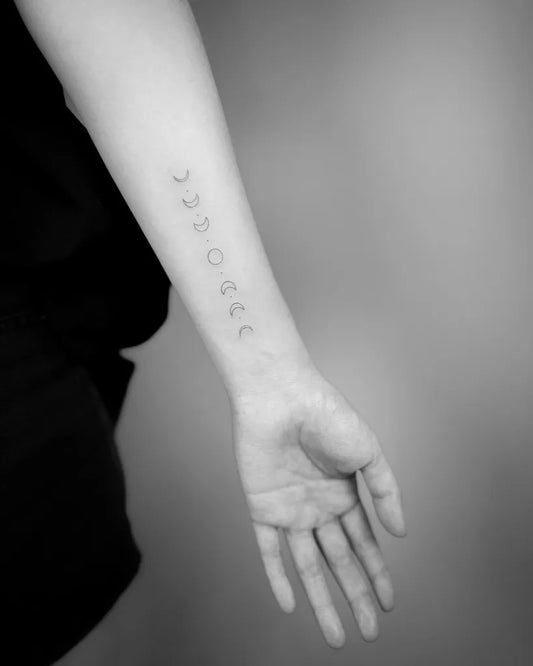 Small Minimalist Moon Phases Tattoo on Women Arm by @shan.6tattoo