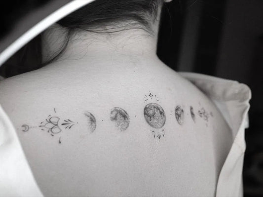 Small Minimalist Moon Phases Tattoo on Women Back by @mendjeli_tattoo