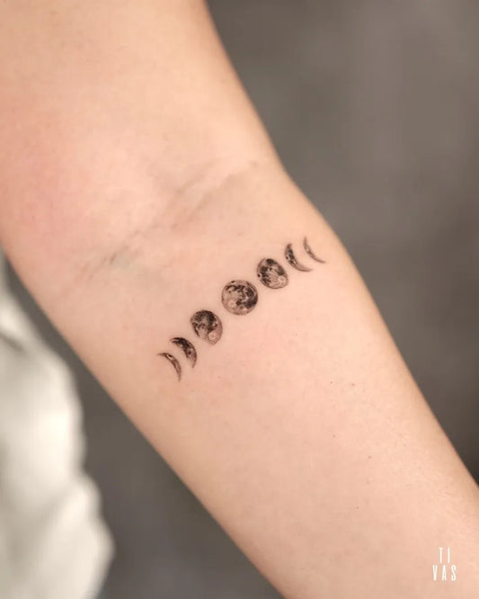 Small Minimalist Moon Phases Tattoo on Women Forearm by @tivas
