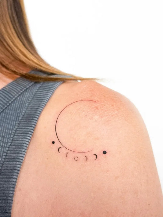 Small Minimalist Moon Phases Tattoo on Women Shoulder by @paula.creart
