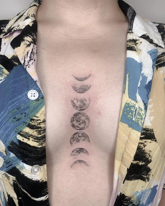 Small Minimalist Moon Phases on Women Sternum Tattoo by @audtats
