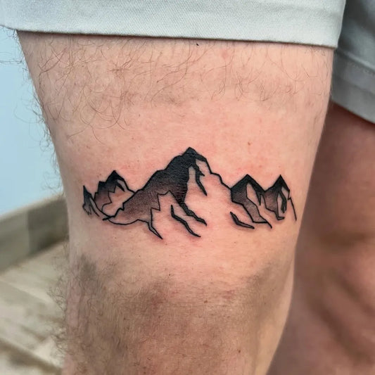 Small Minimalist Mountain Tattoo on Men Leg by @ecwtattoo