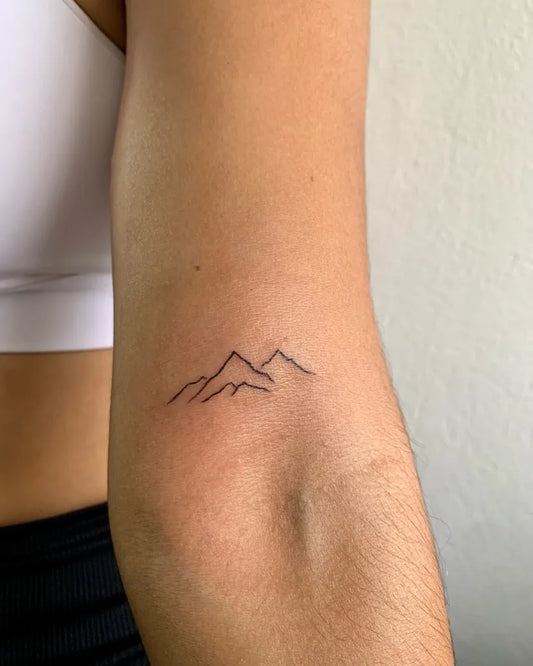 Small Minimalist Mountain Tattoo on Women Arm by @barrqui_tatouage