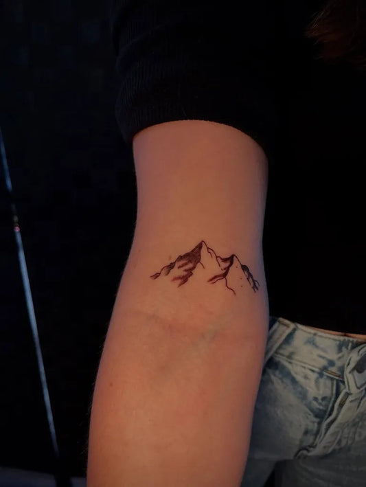 Small Minimalist Mountains Tattoo on Women Arm by @maaadicaaat