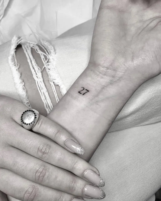 Small Minimalist Number Tattoo on Women Wrist by @moonchild.tattoo