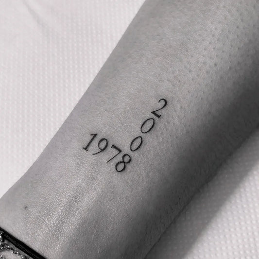 Small Minimalist Numbers Tattoo on Women Forearm by @institut_madame83
