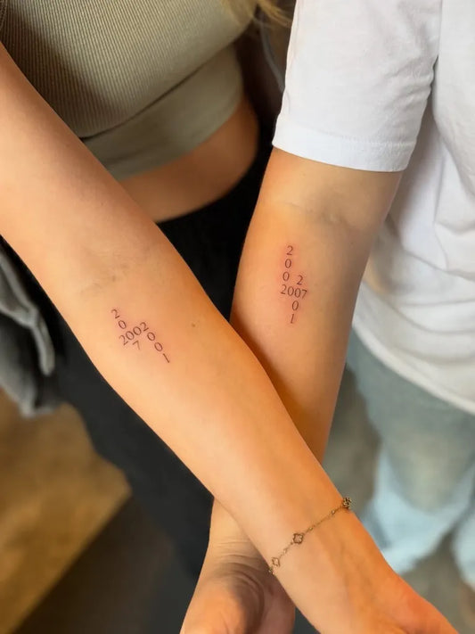Small Minimalist Numbers on Couple Arms Matching Tattoo by @luzanneink
