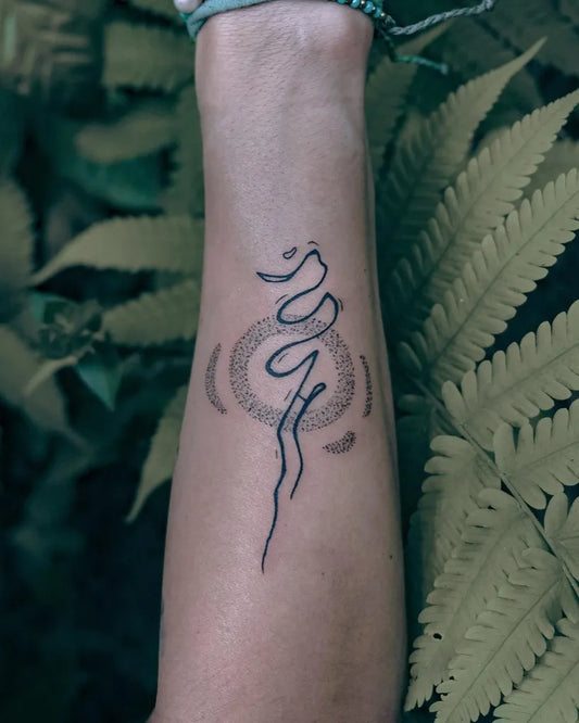 Small Minimalist Om Symbol Tattoo on Women Wrist by @tobb_tattoo