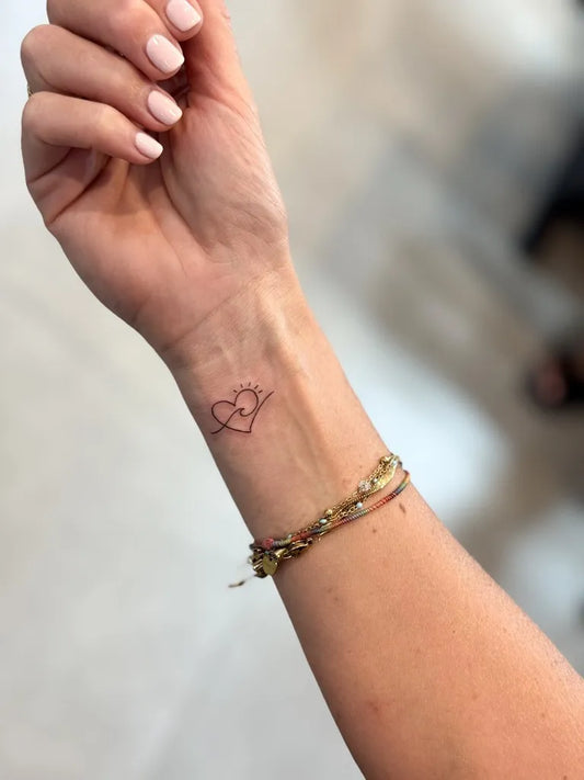 Small Minimalist Open Heart on Women Wrist Tattoo by @inker.ice