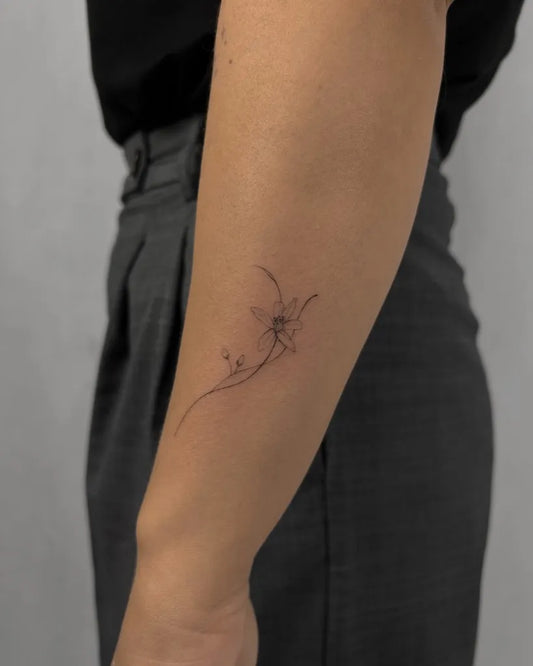 Small Minimalist Orchid Flower with Vines on Women Arm Tattoo by @okvk.tattoo