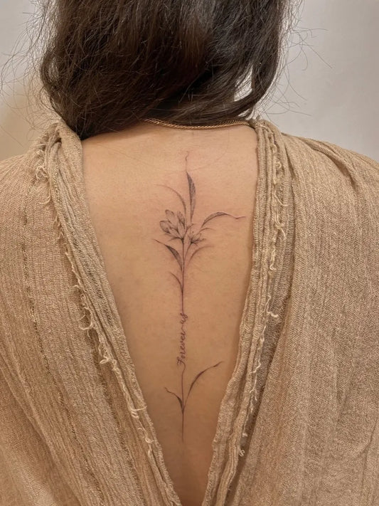 Small Minimalist Orchid stem on Women Back Flower Tattoo by @tattoobydorna