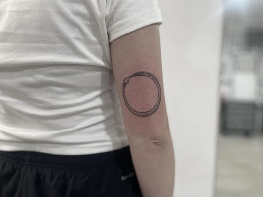 Small Minimalist Ouroboros Tattoo on Women Arm by @bentim_martinez