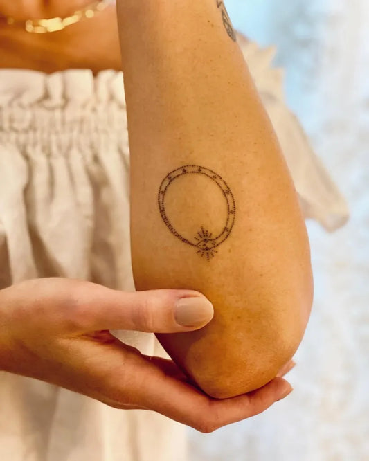 Small Minimalist Ouroboros Tattoo on Women Arm by @bluestonebabe