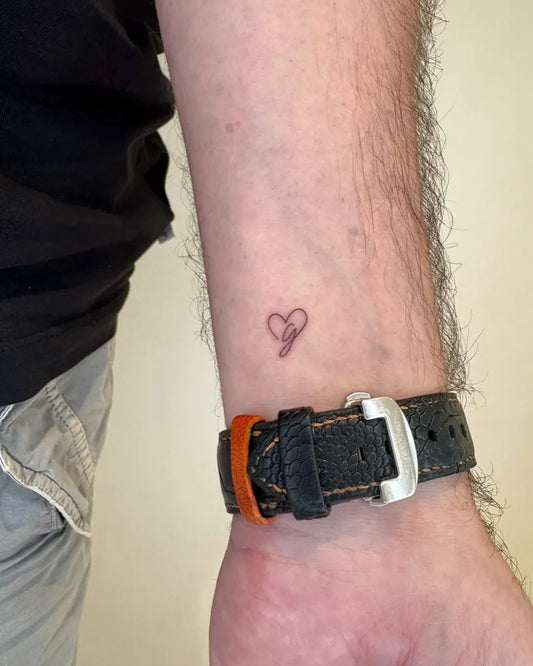 Small Minimalist Outline Heart on Men Wrist Tattoo by @loko_lines