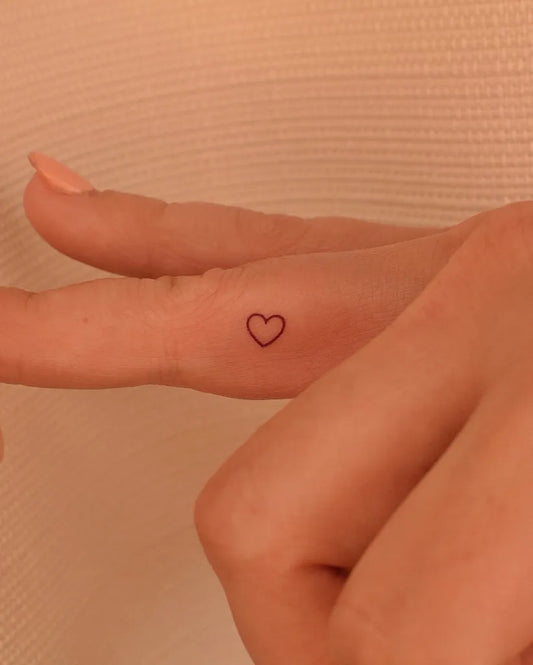 Small Minimalist Outline Heart on Women Finger Tattoo by @tinytattooinc
