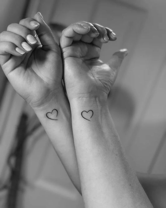 Small Minimalist Outline Hearts on Friends Wrists Matching Tattoo by @gronink.nl