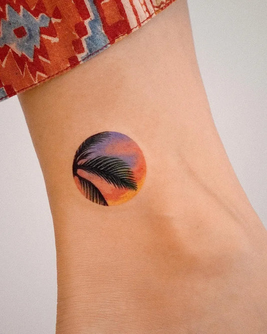 Small Minimalist Palm Tree Sunset Tattoo on Women Ankle by @youngchickentattoo