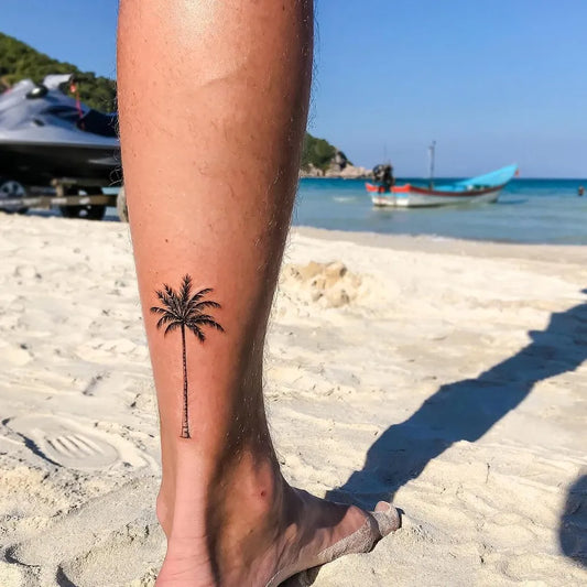 Small Minimalist Palm Tree Tattoo on Men Leg by @tos_tattoo