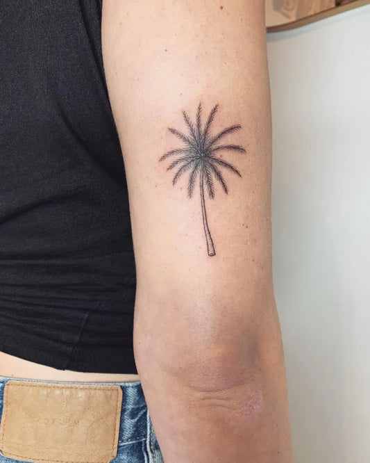 Small Minimalist Palm Tree Tattoo on Women Arm by @jasmineferntattoo