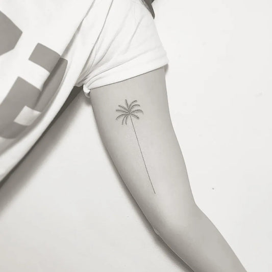 Small Minimalist Palm Tree Tattoo on Women Arm by @masa_tattooer