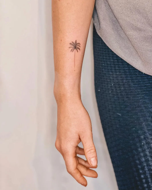 Small Minimalist Palm Tree Tattoo on Women Arm by @the.tinyvegan