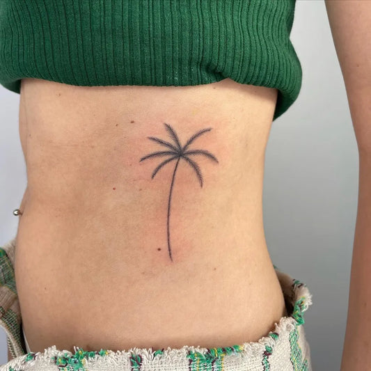 Small Minimalist Palm Tree Tattoo on Women Hip by @amylowdontattoo
