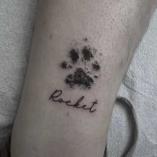 Small Minimalist Paw Print Rocket Tattoo on Women Ankle by @eri.tattoos