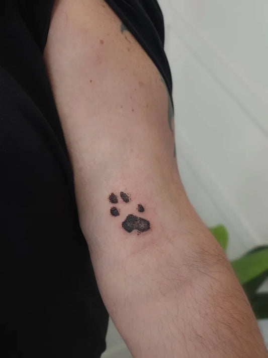 Small Minimalist Paw Print Tattoo on Men Arm by @thesecretfix
