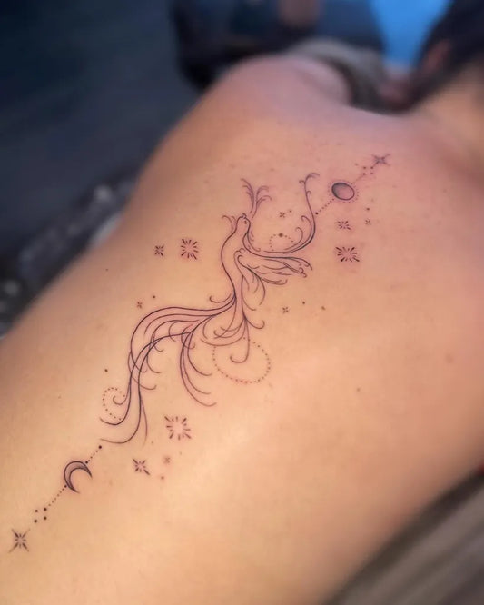 Small Minimalist Phoenix and Stars on Women Spine Tattoo by @saishamaytattoos