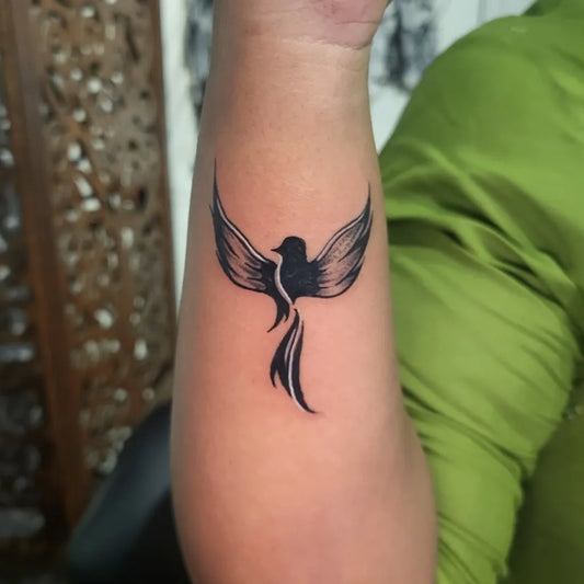 Small Minimalist Phoenix on Women Arm Tattoo by @arthanaari_inks