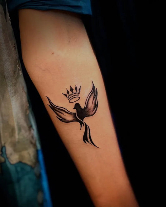 Small Minimalist Phoenix with Crown on Women Arm Tattoo by @sam_tattoosindia