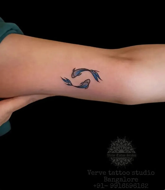 Small Minimalist Pisces Symbol Tattoo on Women Arm by @vervetattoostudio