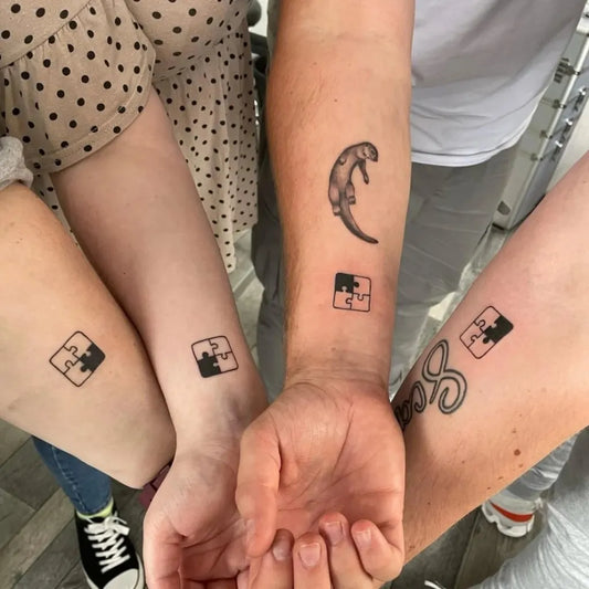 Small Minimalist Puzzle Otter on Friends Arms Matching Tattoo by @gentlemangeorgestattooparlour
