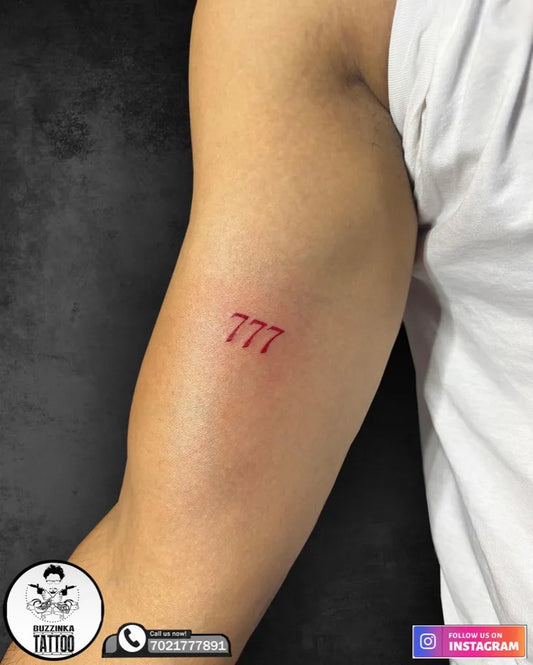 Small Minimalist Red 777 Tattoo on Men Arm by @buzzinkatattoos_mumbai