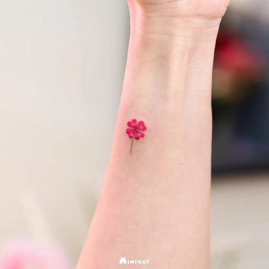 Small Minimalist Red Clover on Women Wrist Tattoo by @minicat_tattoo