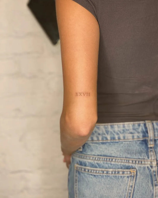 Small Minimalist RomanNumerals on Women Arm Tattoo by @tattoovasquez