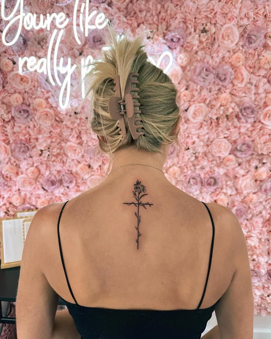 Small Minimalist Rose Cross on Women Spine Tattoo by @roseinkofficial