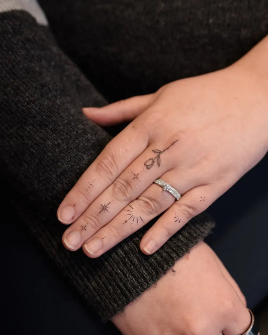 Small Minimalist Rose and Stars on Women Hand Tattoo by @tavi_tattoo