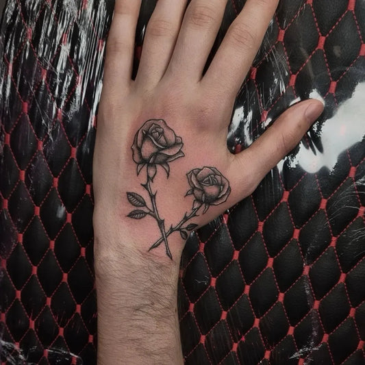 Small Minimalist Roses on Men Hand Tattoo by @lastangeltattoo
