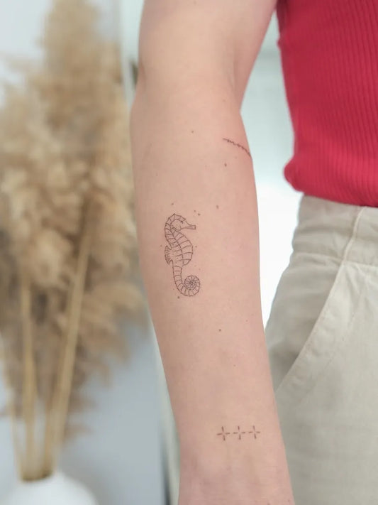 Small Minimalist Seahorse on Women Arm Tattoo by @noemiedn_tattoo